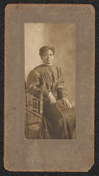 Photograph, Woman sitting sideways on a chair