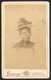 Photograph, Woman wearing a hat and glasses, front