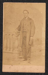 Photograph, Standing man posing with banister, front