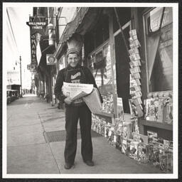 Sammy Cutrona, Jr. poses, holding a paper, along King Street near 4th Street in Wilmington, Delaware.