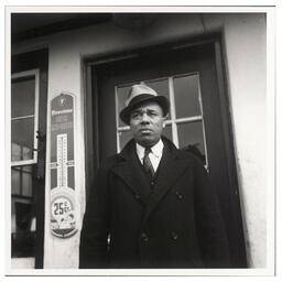 Fletcher G. White poses at door to White's Quick Service Station, 828 Walnut St., Wilmington, Feb 23 1938. 