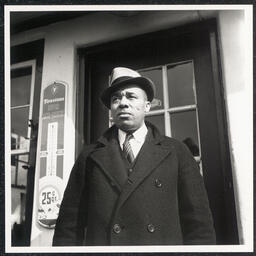 Fletcher G. White poses at door to White's Quick Service Station, 828 Walnut St., Wilmington, Feb 23 1938.