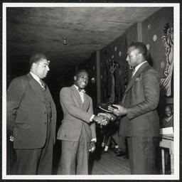 Roosevelt M. Franklin (middle) receiving an award from Millard A. Naylor (left) and Dr. Jerome Budd Howland (right) at Howard High School Awards Night. Franklin eventually became president of the NAACP in Delaware.