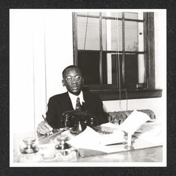 Howard High School 1320 Poplar St., Joseph Anderson Morris at desk, 1940