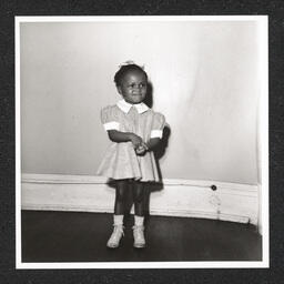 St. Michael's Day Nursery for Colored Children, a girl poses and smiles, 1940